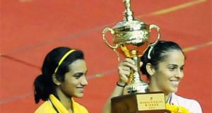 Saina Nehwal poses with the winner's trophy after defeating PV Sindhu in the Syed Modi International India Grand Prix Gold final.