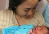 Koo Kien Keat's wife Audrey Tan Su Ven is holding their newborn son Dayson.