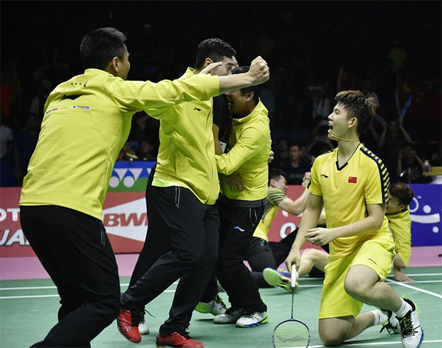 Chinese players storm the court after the Li Junhui/Liu Yuchen clinch the winning point for China. (photo: AP)